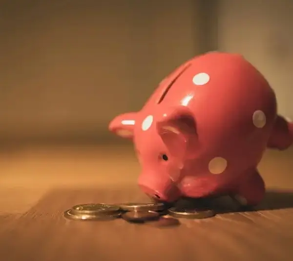 Piggy bank eating coins, money habits