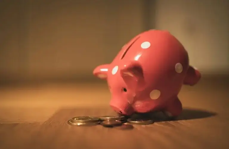 Piggy bank eating coins, money habits