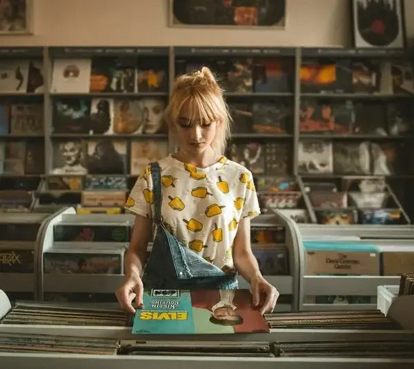 Person looking at record albums in a record store, Elvis,