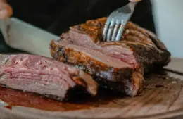 Person slicing roast beef