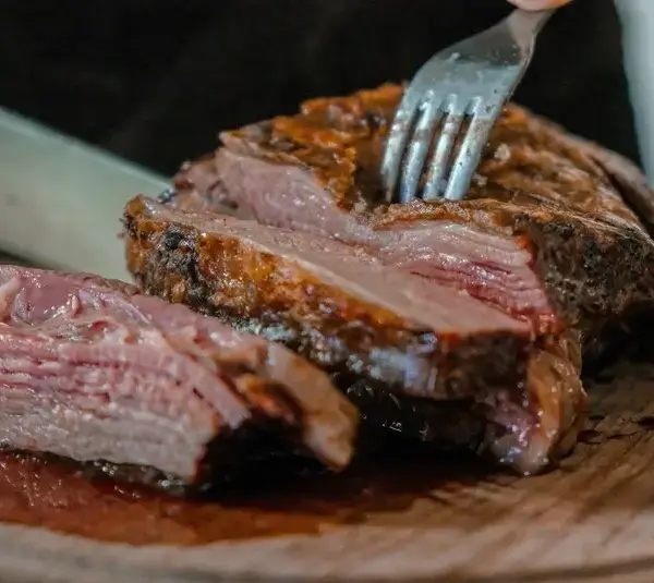 Person slicing roast beef