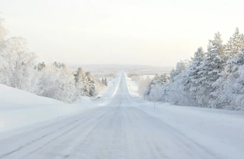 Ice roads in Lapland, road covered in snow, winter travel