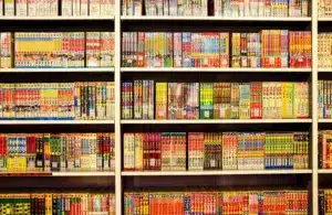 Bookshelf lined with colorful manga volumes in Japanese, organized neatly in rows. Vibrant covers create a lively and inviting atmosphere. Free Comic Book Day 2026