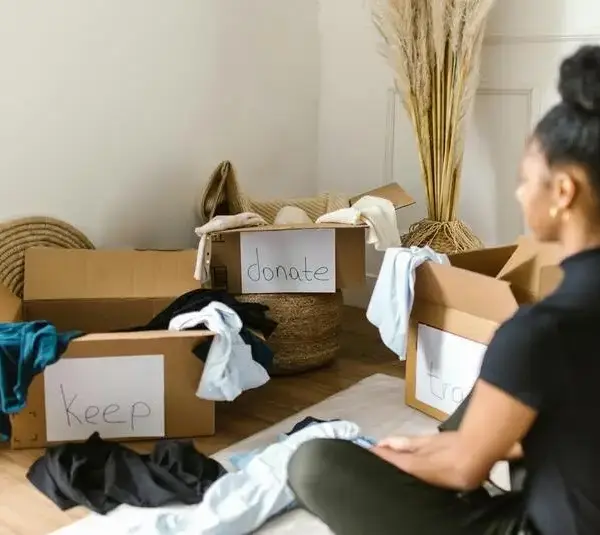 Woman sorting things, decluttering, donate,