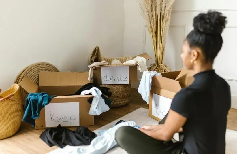 Woman sorting things, decluttering, donate,