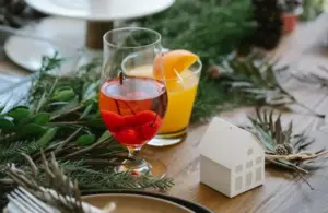 Glasses of tasty cocktails on a table with Christmas decor. These can be some great seasonal cocktails., non-alcoholic drinks