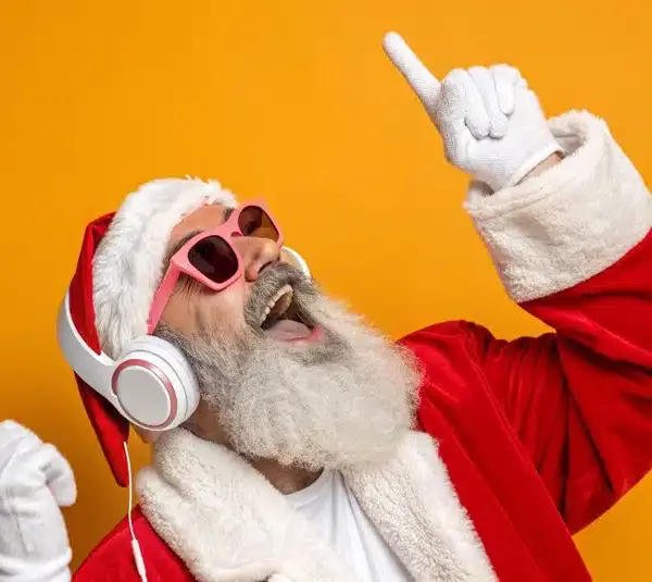 Santa Claus is listening to Christmas Songs with headphones on.