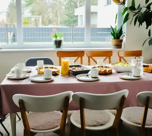 A table set for multiple people with breakfast foods. Brunch table, meal