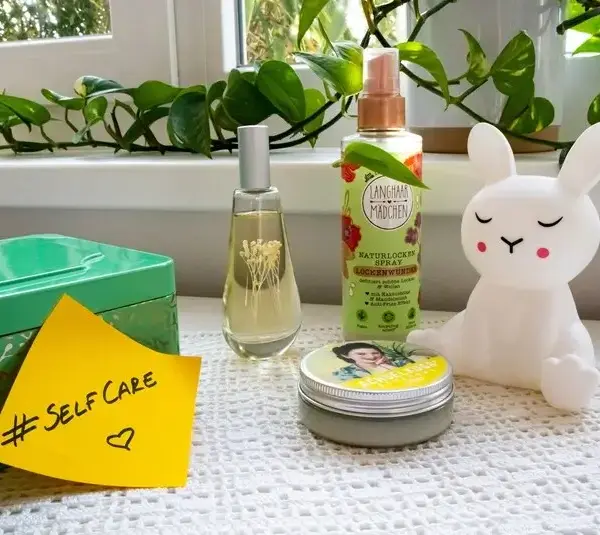 Dresser with cosmetic products and a sticky note with the hashtag #selfcare on it, self-care, self care