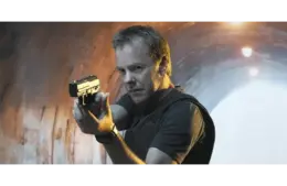 Kiefer Sutherland as Jack Bauer aiming a pistol, standing in a dimly lit tunnel