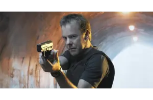 Kiefer Sutherland as Jack Bauer aiming a pistol, standing in a dimly lit tunnel