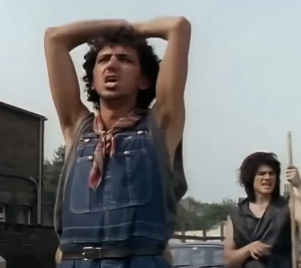 Dexys Midnight Runners perform "Come On Eileen" on a street corner in a music video for the song.
