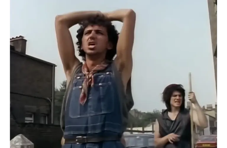 Dexys Midnight Runners perform "Come On Eileen" on a street corner in a music video for the song.