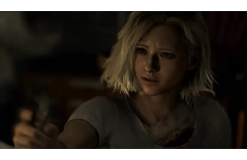 A young woman with short blonde hair holds an object with intent, wearing a distressed expression. Her white shirt is stained, and the atmosphere is tense and dark. Grace Ashcroft from Resident Evil Requiem, Courtesy of Capcom Co., LTD.