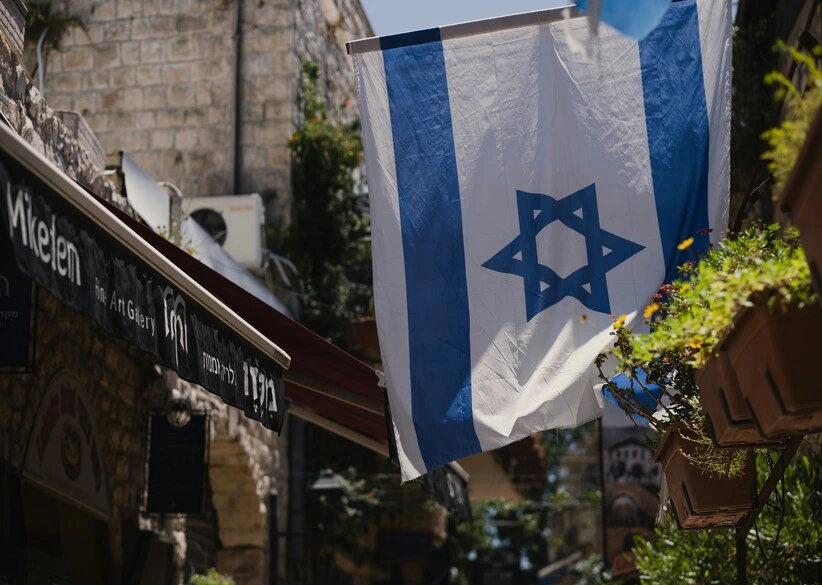 Image of the flag of Israel flying on a short pole above the entrance to a building, Genesis, Old Testament