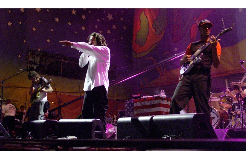 Rage Against the Machine perform Saturday night at Woodstock '99 at Griffiss Park in Rome, NY. From left are bassist Tim Commerford and lead singer Zack de la Rocha and guitarist Tom Morello.