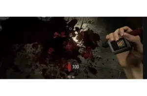 Grace's hand is holding a device next to a dark, bloody floor in Resident Evil Requiem. The scene is intense and somber, with a bright screen bar visible on the device, adding tension.