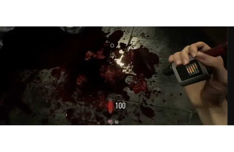 Grace's hand is holding a device next to a dark, bloody floor in Resident Evil Requiem. The scene is intense and somber, with a bright screen bar visible on the device, adding tension.