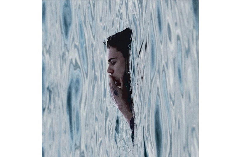 The album cover of The Kid Laroi's album, Before I Forget, features a man submerged up to his face in water.
