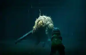 A character in End of Abyss in a green coat faces a large grotesque creature wielding a sword in a dark, eerie setting. The atmosphere is tense and foreboding.