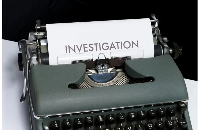 Why Cold Cases Remain Unsolved with an old typewrite with the word "Investigation" written on paper.