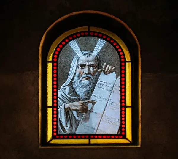 Stained glass, moses from the book of Exodus, paint-on-glass window, inside a cemetery sepulcher (a small, upright stone chapel above a burial plot).