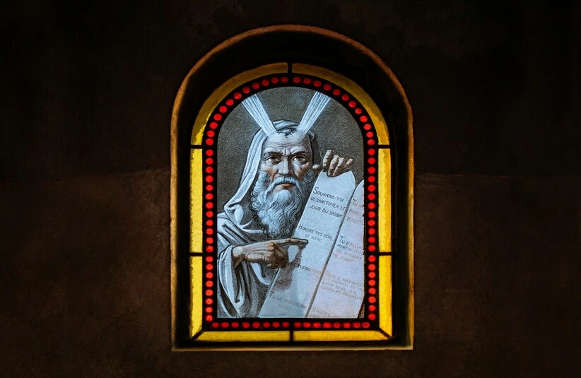 Stained glass, moses from the book of Exodus, paint-on-glass window, inside a cemetery sepulcher (a small, upright stone chapel above a burial plot).
