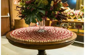 a beautiful valentine centerpiece on a table with a table mat