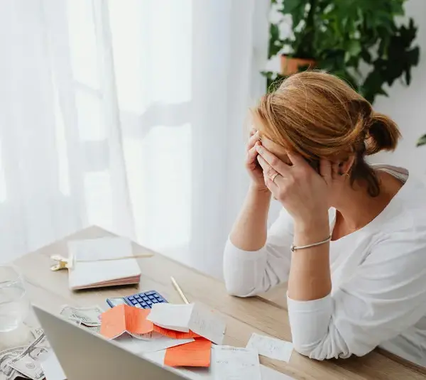women in financial stress on her office table