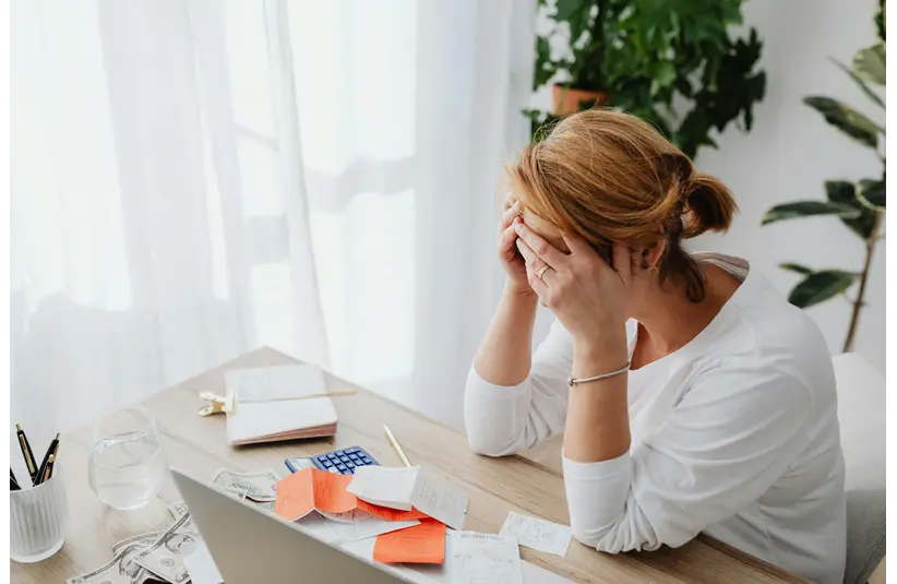women in financial stress on her office table