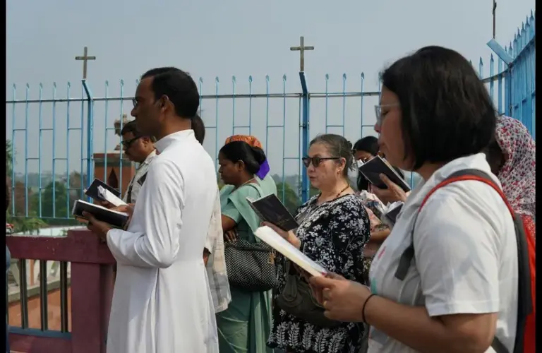 For the week of prayer a group of people are praying and reciting short readings along with their priest.
