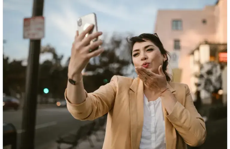 woman blowing a kiss to a loved one/ long-distance relationship