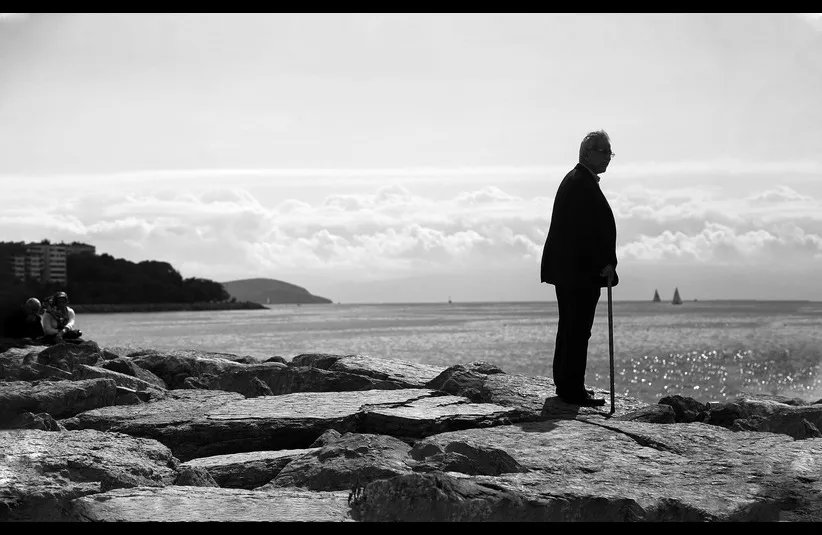 In the daily devotional, an old man stands by the seaside.