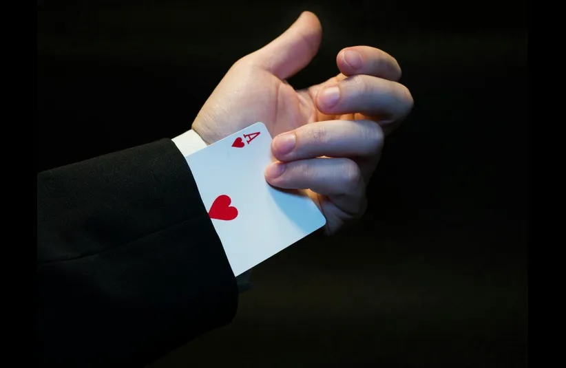 Daily devotion image shows magician with a hidden card coming out of his sleeve