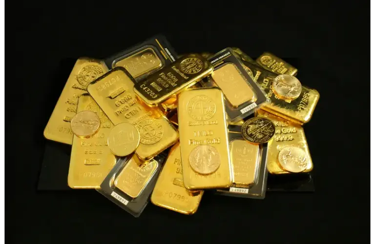price of gold-Gold Bars and Coins on a Black Surface