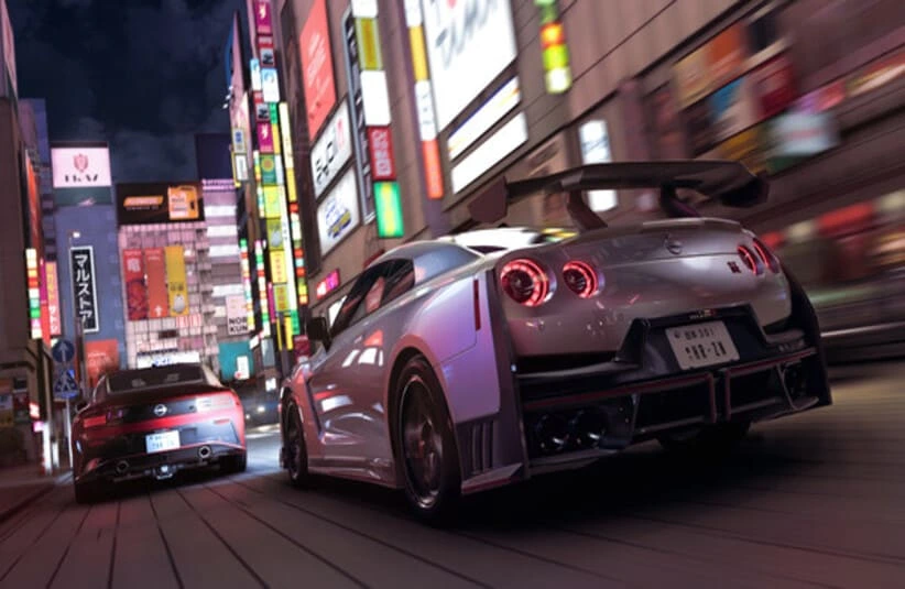 Two sporty cars speed down a neon-lit urban street at night in Forza Horizon 6, surrounded by bright, colorful signs and tall buildings, creating an energetic atmosphere.