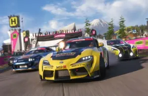 Three race cars speed around a track in Forza Horizon 6, led by a yellow car, with a mountain and cheering crowd in the background. Energetic and competitive vibe.