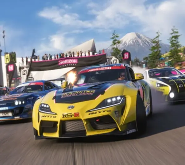 Three race cars speed around a track in Forza Horizon 6, led by a yellow car, with a mountain and cheering crowd in the background. Energetic and competitive vibe.