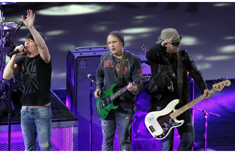 Jan 30, 2011; Raleigh, NC, USA; Recording artist Brad Arnold (left) of the band 3 Doors Down performs during the first intermission of the 2011 All Star game at RBC Center.
