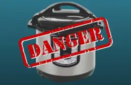 A Gourmia pressure cooker on a blue background with a bold red "DANGER" stamp overlay, conveying a warning or risk message.