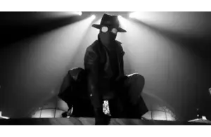 Spider-Noir crouches in dramatic black-and-white lighting. Circular glasses and a mask add intrigue; a tense, shadowy atmosphere.