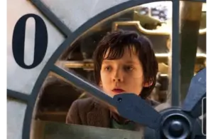 Best steampunk films - “Hugo” - image of Asa Butterfield examining an automaton clock