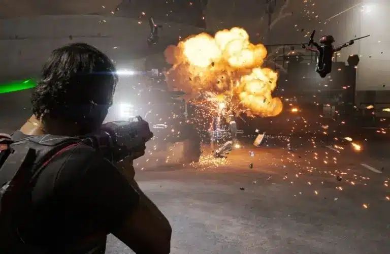 A person in Mindseye game fires a weapon at explosive barrels, causing a fiery explosion with flying debris and sparks. Drones hover nearby, creating an intense, chaotic scene.