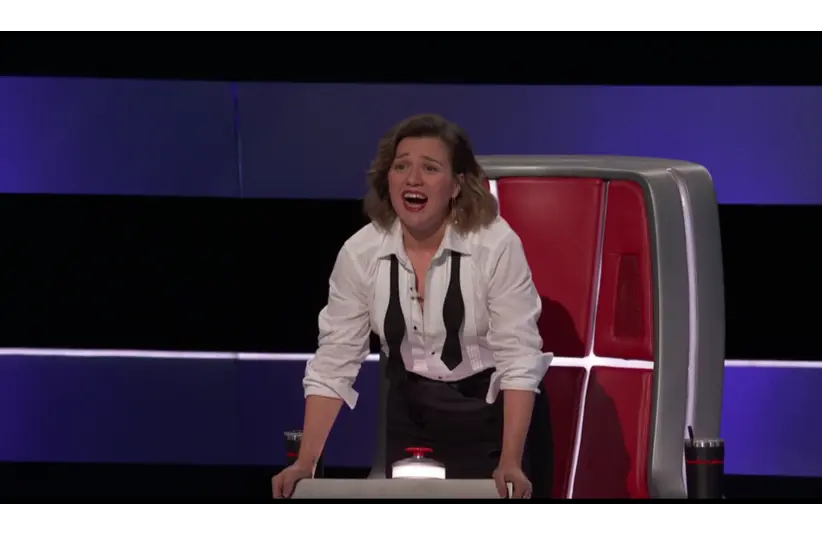 Screenshot of Kelly Clarkson on The Voice Season 29, Episode 1 begging for Jonah Mayor to join her team