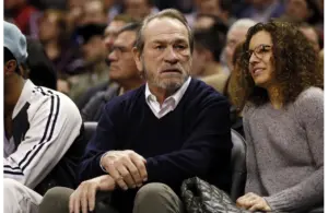 Dec 25, 2013; San Antonio, TX, USA; Tommy Lee Jones (left) and his wife Dawn Laurel-Jones (right) in attendance during the first half against the Houston Rockets at AT&T Center. Mandatory Credit: Soobum Im-Imagn Images