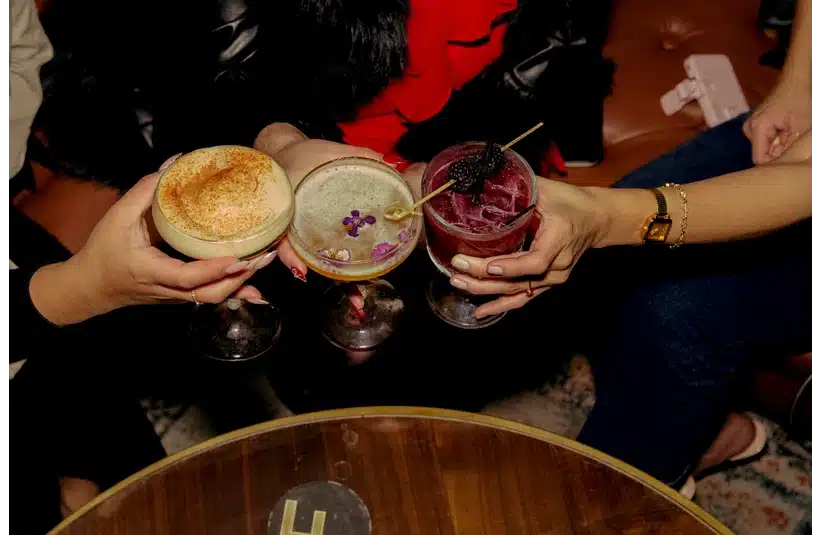 Three friends out enjoying different mocktails