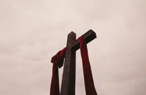 A cross from a low angle draped with red fabric, Good Friday, Easter, Catholic, Christian