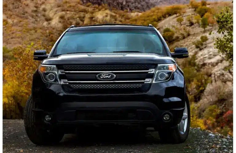 Black Ford Explorer from the front parked on the side of a road with hills behind it. Part of Feb 2026 recall.