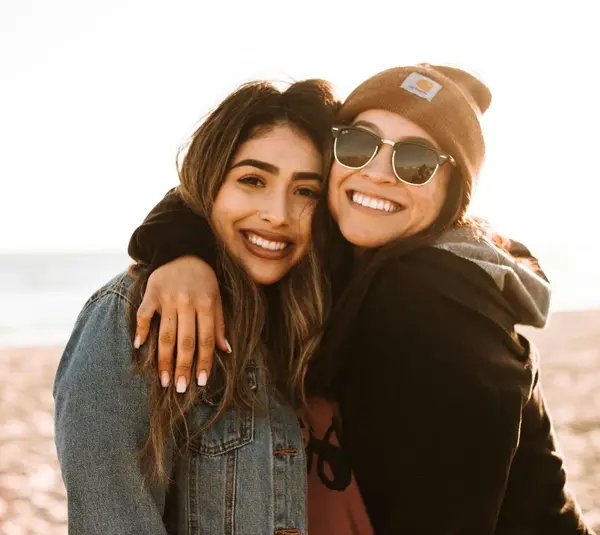 Single friend hugging another friend