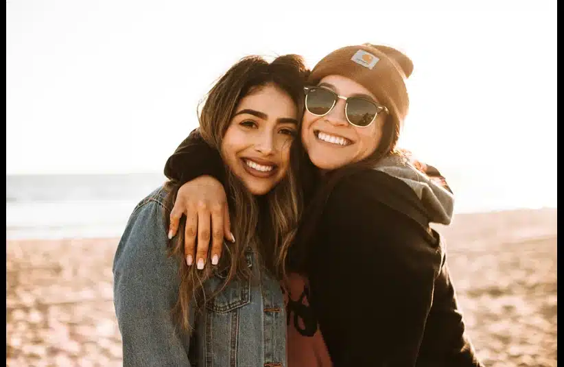 Single friend hugging another friend